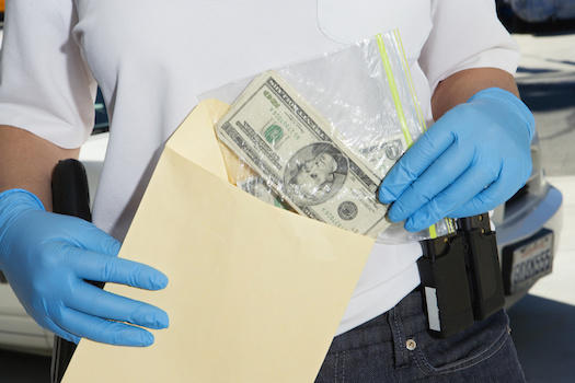 Police Officer Putting Money Away